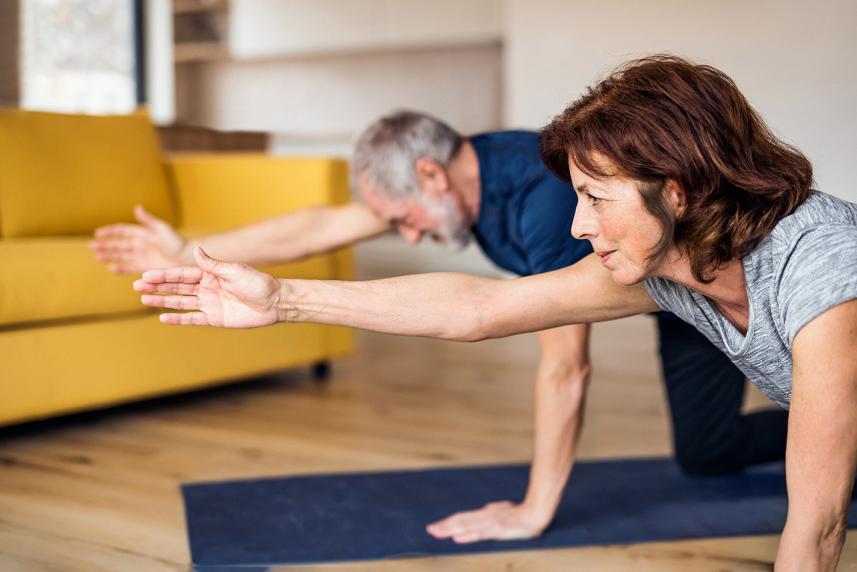 Man and woman doing yoga for an article on  how to lower blood pressure